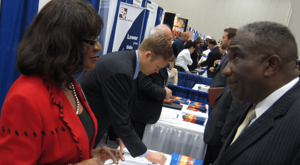 department of transportation small business specialist meets with a business owner at the government procurement conference