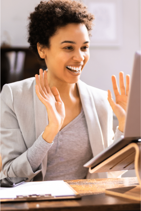 Smiling professional woman engaging on a video call, representing a federal buyer responding positively to vendor follow-up