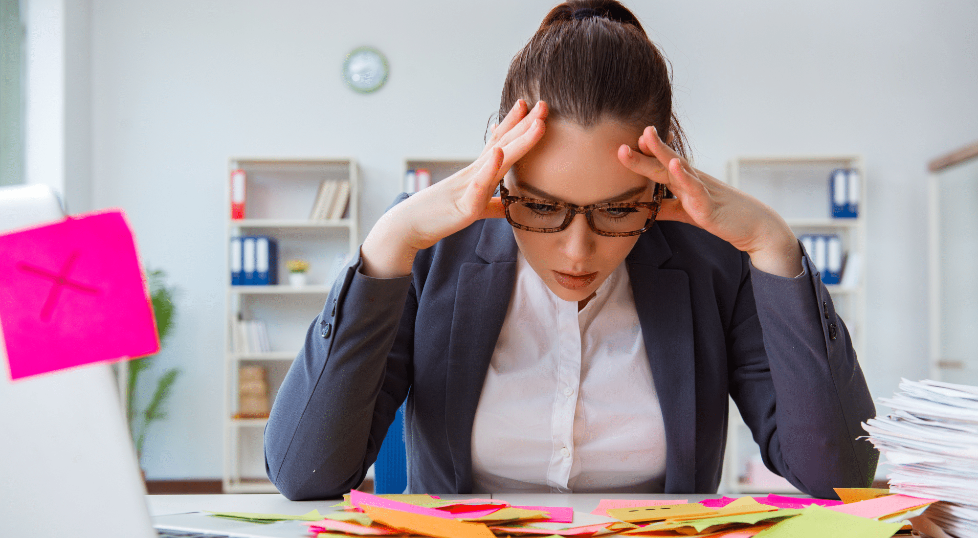 Stressed federal employee at cluttered desk during fiscal year-end deadline