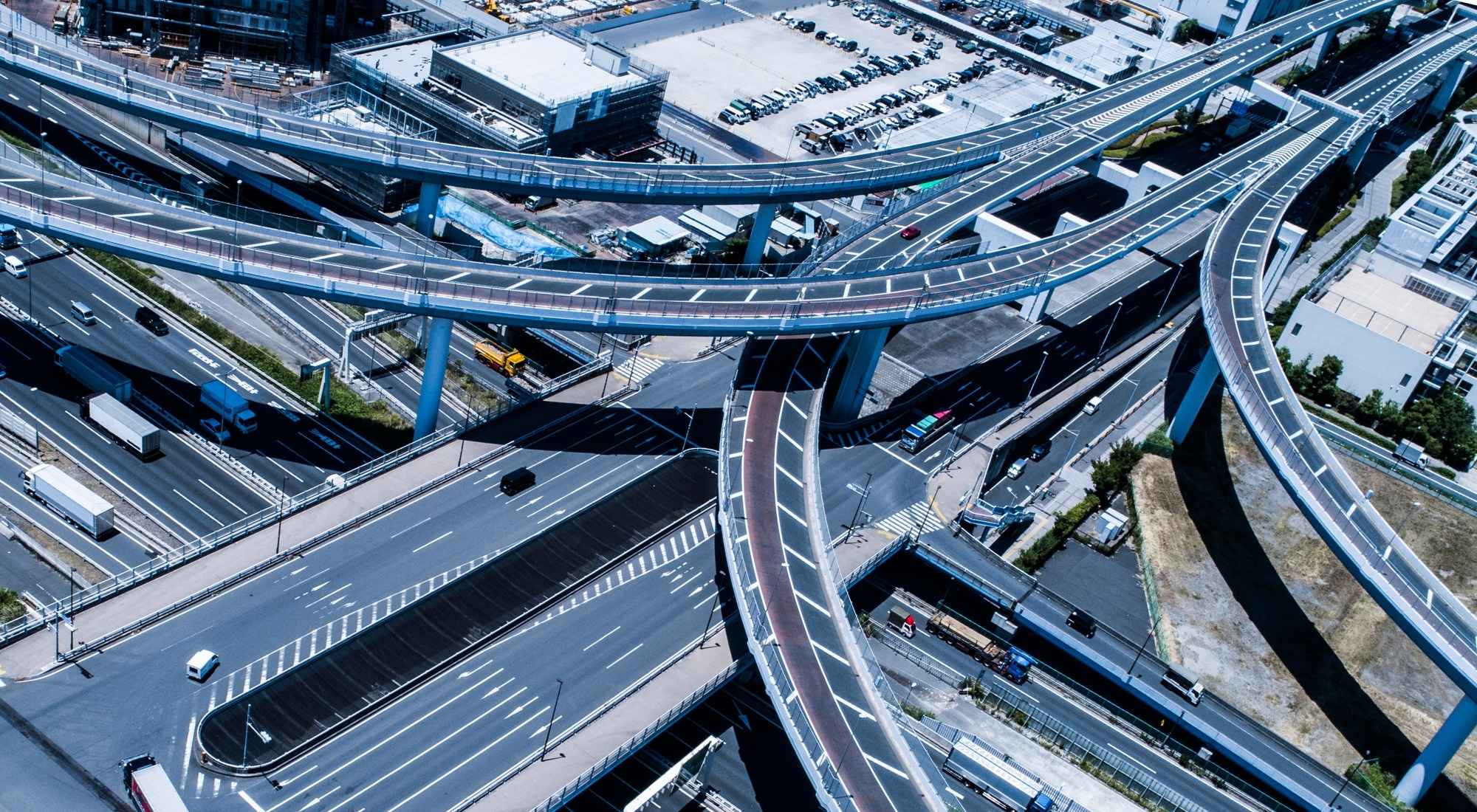 Multiple highway lanes merging into one corridor, symbolizing federal contract consolidation in FY26 for small businesses.