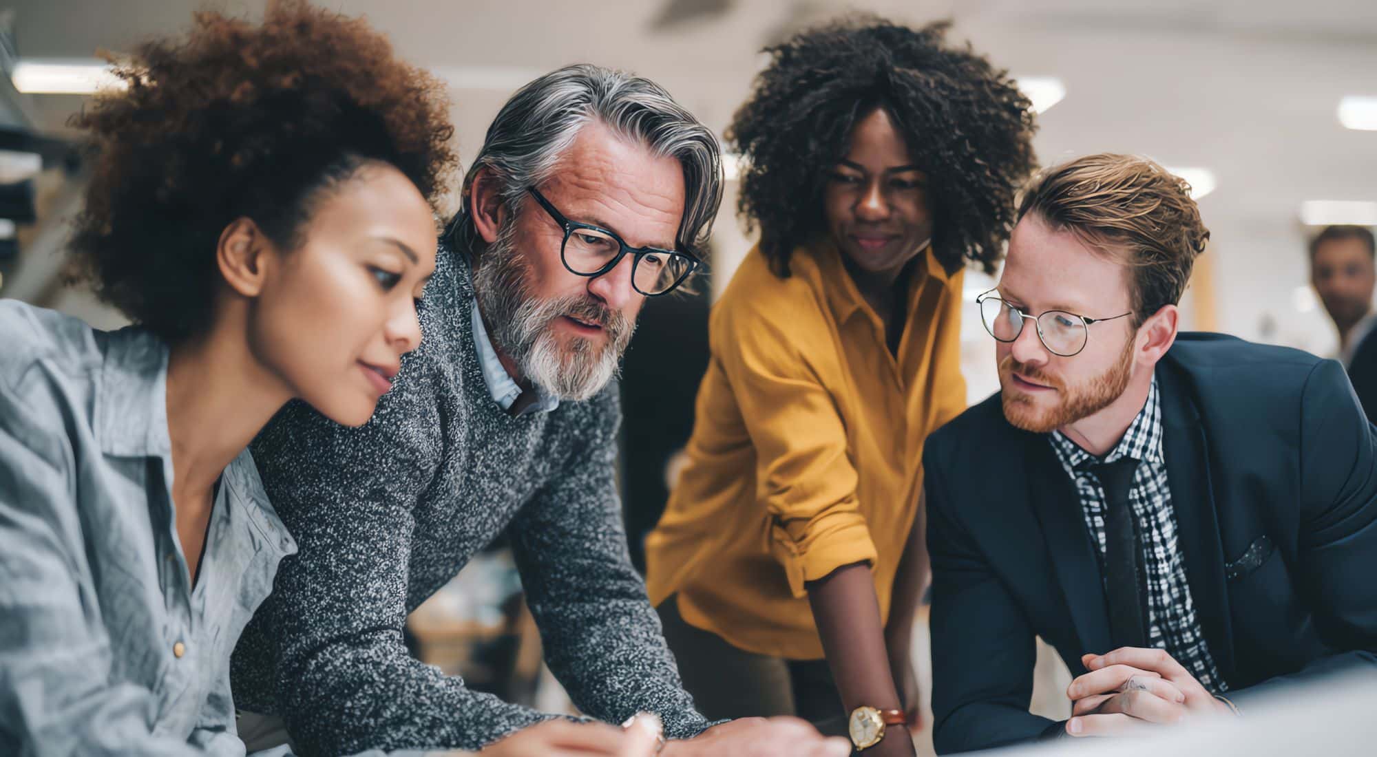 Diverse Federal business development team collaborating and reviewing insights during a Hot Wash meeting to improve performance and trust.